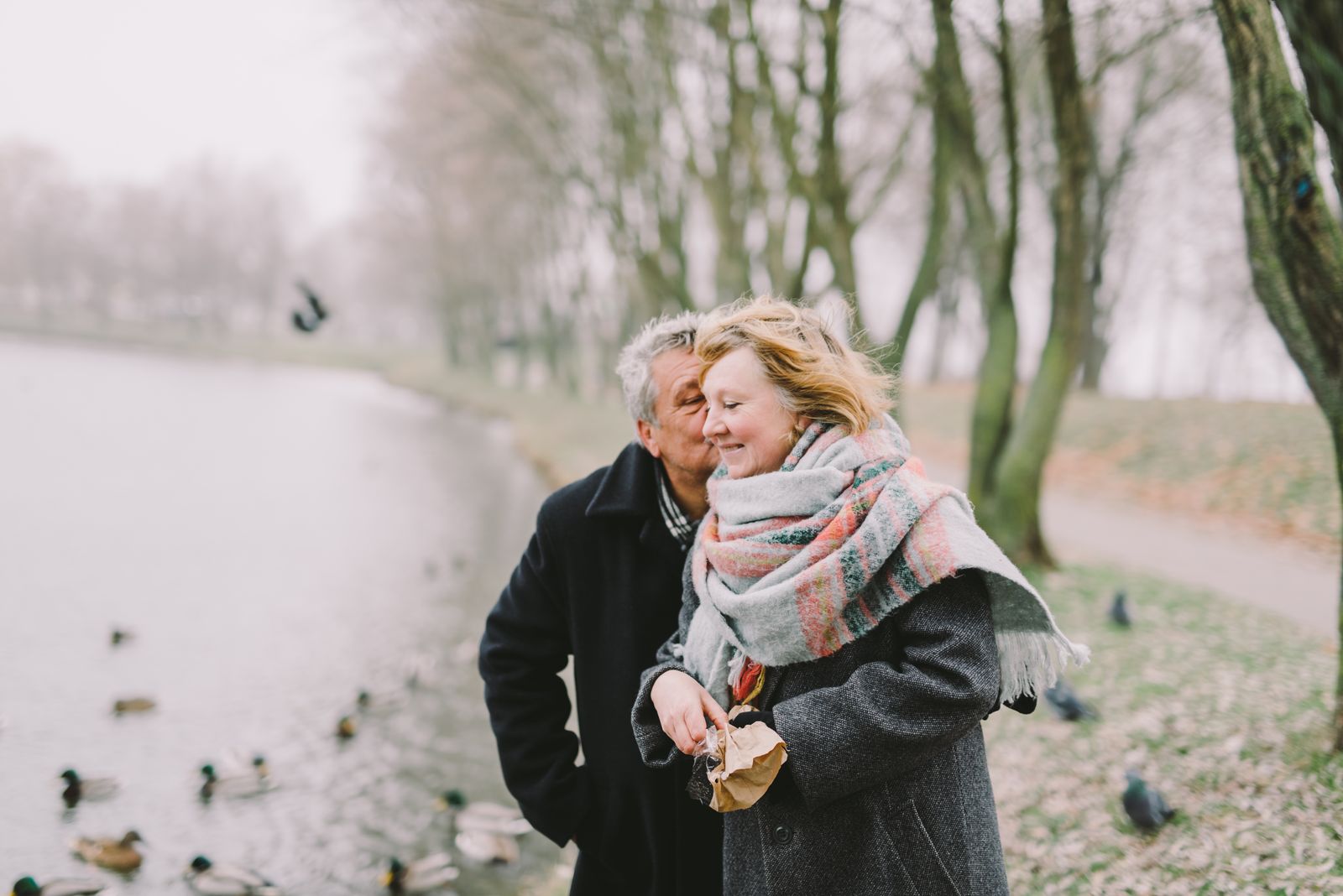A retired couple enjoying a walk by the lake