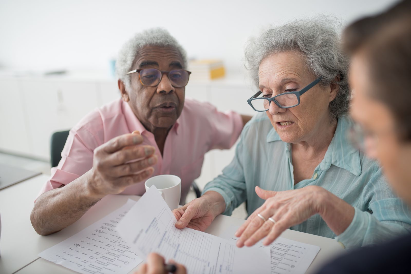 A couple reviewing their Medicare paperwork with an advisor